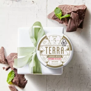 Peppermint Pattie Bites tin with dark chocolate patties on a soft surface