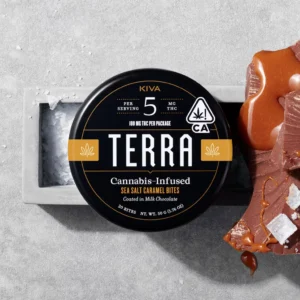 Sea Salt Caramel Terra Bites tin with chocolate-covered almonds on a marble surface